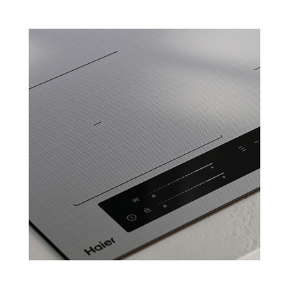 Close up angle view of the Haier induction cooktop in grey showcasing the quality design, touch controls and sleek design.