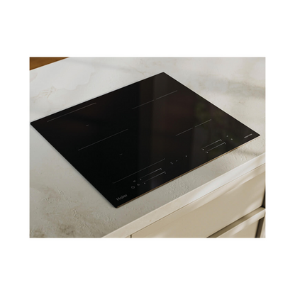 Angled image of a Haier induction cooktop in a lifestyle setting installed on a white marble benchtop.