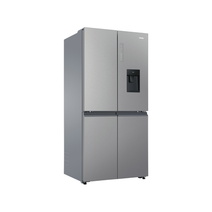 Angle view of the Haier 507L quad door fridge with the doors closed in a satina finish, showing the water and ice dispenser, electric controls on the right door and flat door design.