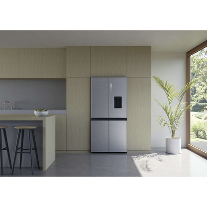 Front view of the Haier 507L quad door fridge with the doors closed in a Satina finish, in a modern kitchen layout, showing its modern flat door design.