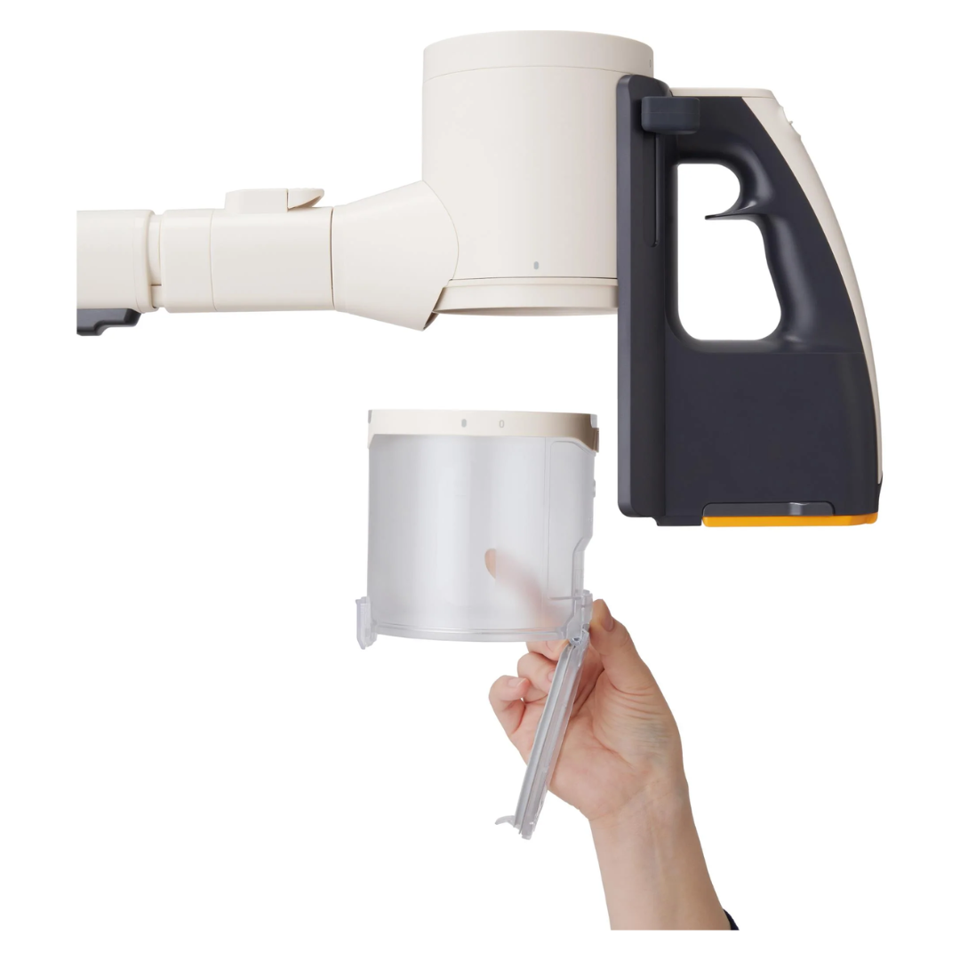 Hand holding a LG white and black vacuum collection bin on a white background