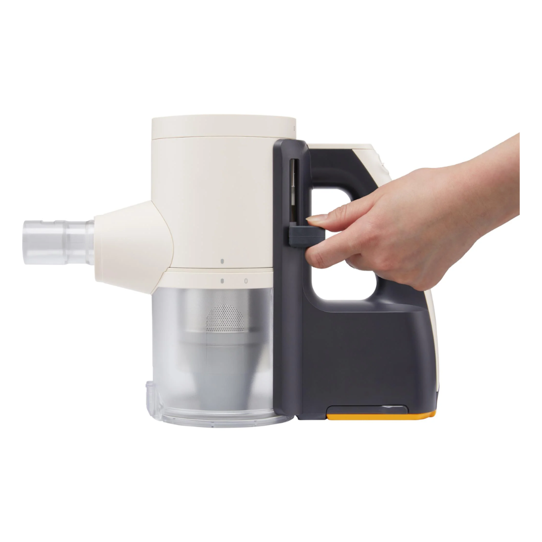 Hand holding a gray and white handheld LG vacuum cleaner on a white background