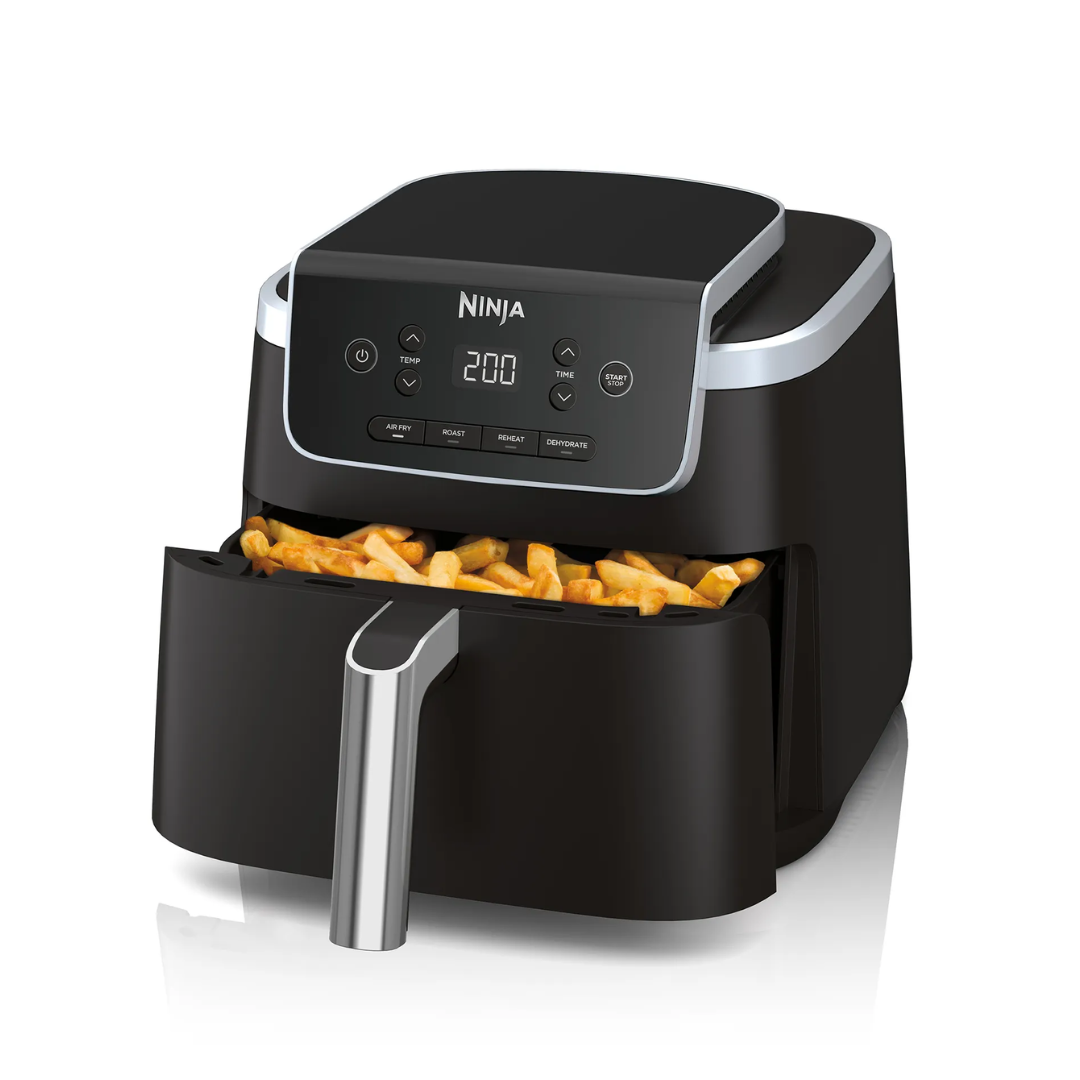Ninja air fryer with fries inside on a white background