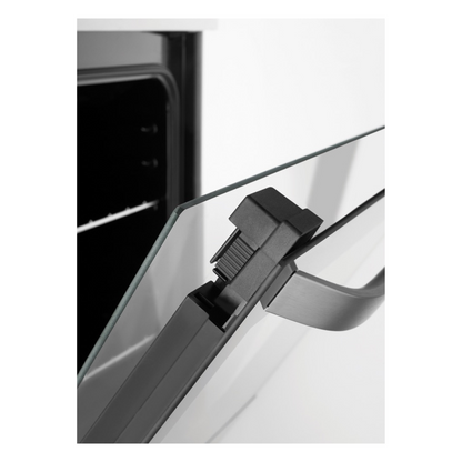 Close up view of the oven door slightly opened, showing the thickness of the glass as well as the handle.
