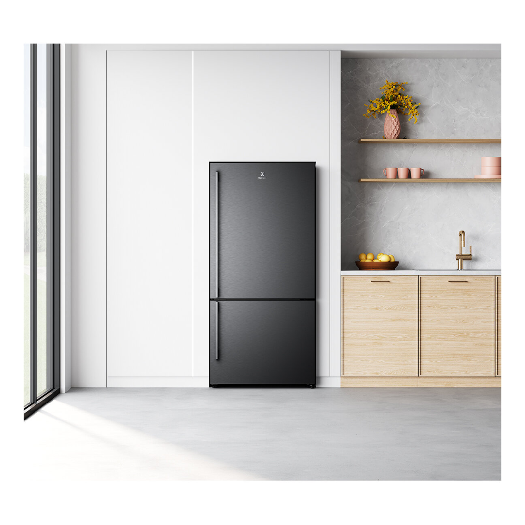 A front view of the Electrolux 496L bottom mount fridge in a dark stainless steel finish in a modern kitchen setting  