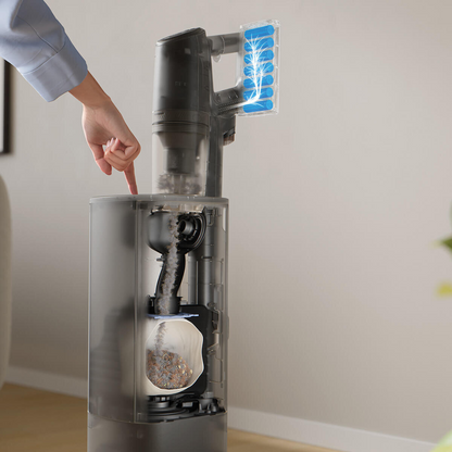 Electrolux 800 series cordless stick vacuum with clean station, illustrating dust being automatically emptied into a bagged container, showing hygienic hands free dirt disposal. 