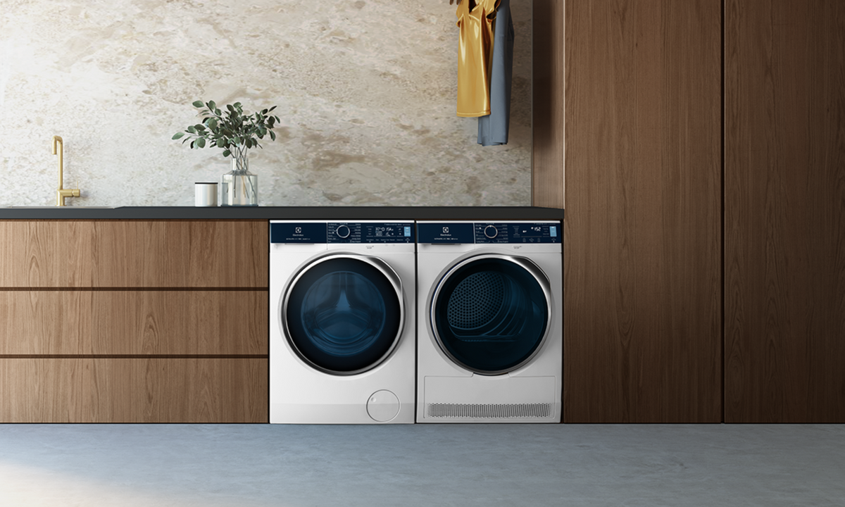 Electrolux Washer and Dryer matching pair in a wood paneled laundry room