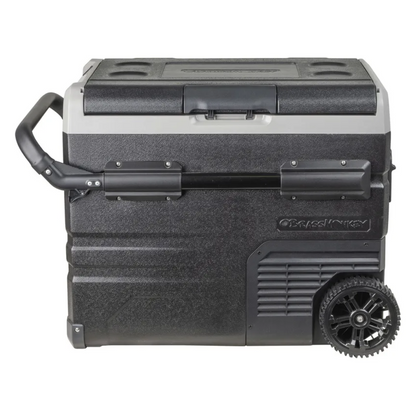 Brass Monkey portable fridge/freezer with lid closed, heavy-duty wheels and extendable handle, ideal for camping, travel and outdoor use.