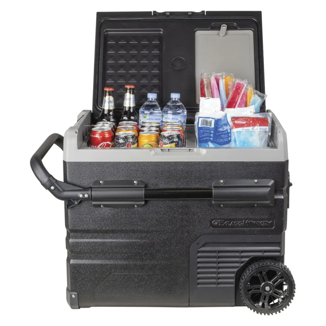 Brass Monkey dual zone portable dual-zone fridge freezer with lid open, stocked with drinks and ice locks, featuring rugged wheels and handle for outdoor camping.