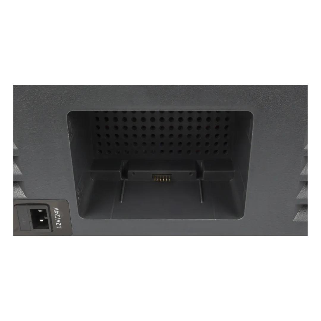 Close-up view of the Brass Monkey dual zone portable fridge/freezer battery compartment with integrated connector pins for removal lithium battery, alongside 12V/24V input socket for vehicle or solar charging.
