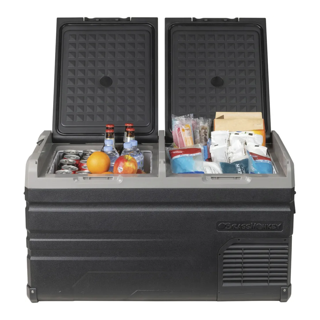 Brass Monkey dual zone fridge/freezer with both lids open showing stored beverages, fruits and frozen food, ideal for camping, travel, and outdoor adventures.