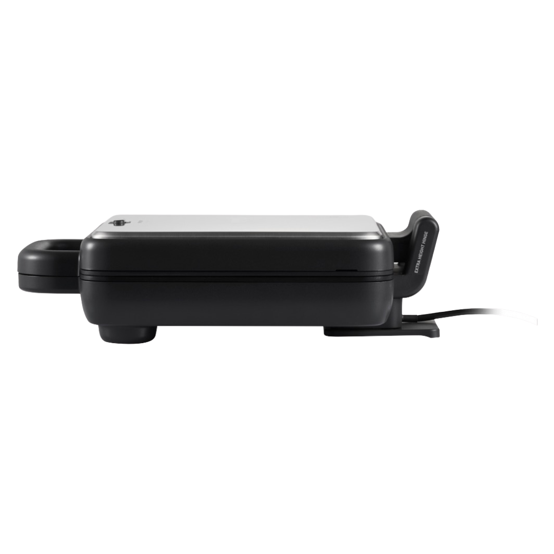 Side view of a closed Sunbeam sandwich press with stainless steel lid, showing its compact profile, rubber feet for stability, and cord extending from the base. 