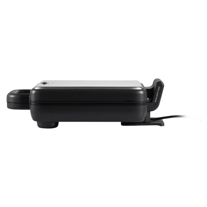 Side view of a closed Sunbeam sandwich press with stainless steel lid, showing its compact profile, rubber feet for stability, and cord extending from the base. 