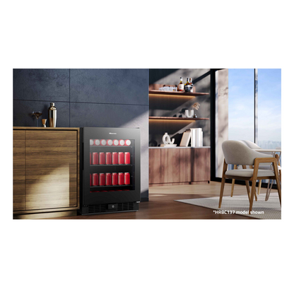 Angled view of the Hisense 140 can beverage cooler in a black finish, in modern bar area with wooden cabinetry and wooden furniture nearby. 