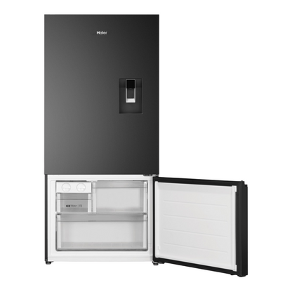 Haier Bottom Mount Fridge with a water dispenser in Black with the freezer compartment open showcasing it's storage capacity