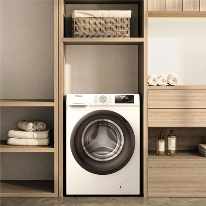 Front view of the Hisense 7.5kg front load washing machine in a white finish, in a modern laundry room, with wooden shelving besides it, with towels and detergents nearby. 