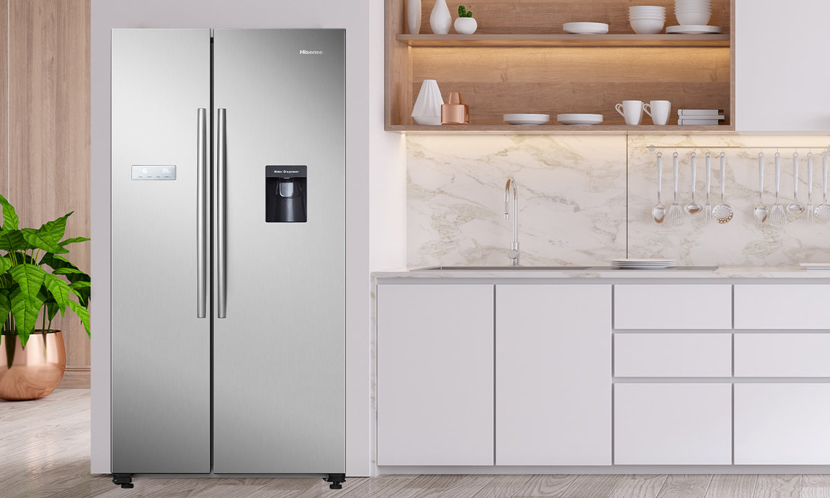 Hisense Side by Side Fridge in stainless steel in a white kitchen with marble, wood and silver elements