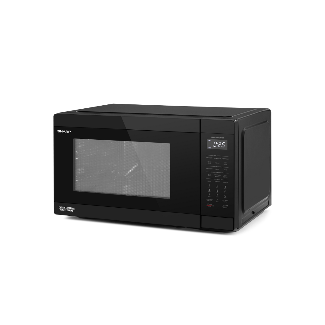 Black Sharp microwave oven at an angle on a white background