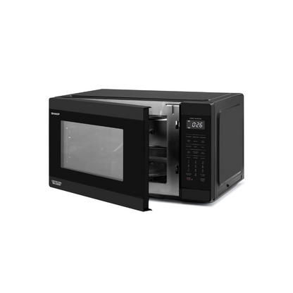 Black Sharp microwave oven with digital display at an angle with the door slightly open on a white background