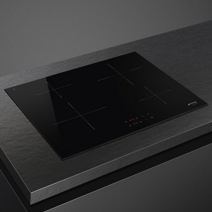 Smeg 60cm Induction Cooktop 4 zone induction cooktop pictured at an angle on a modern counter top