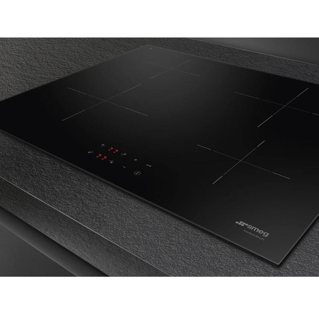 Smeg 60cm Induction Cooktop 4 zone induction cooktop pictured at an angle on a modern counter top 