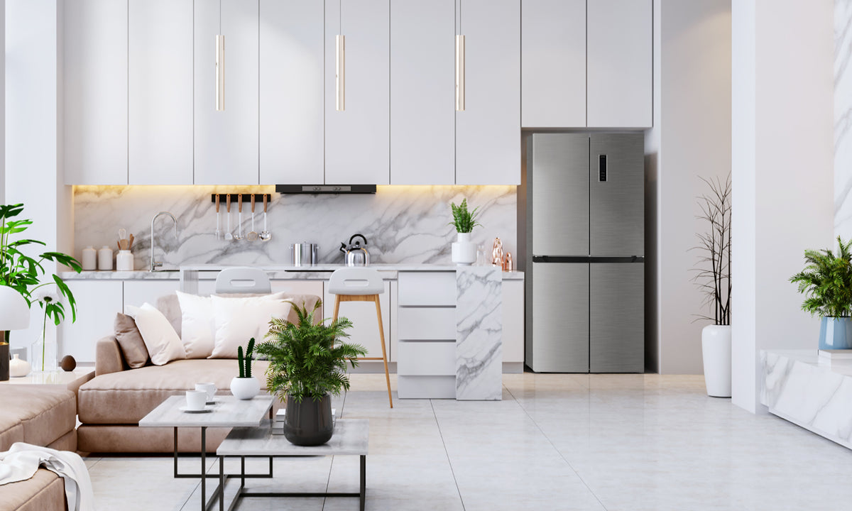 A white modern kitchen with marble tiles and extra tall cabinets contrasts with the Stainless Steel TCL fridge built under the cabinets