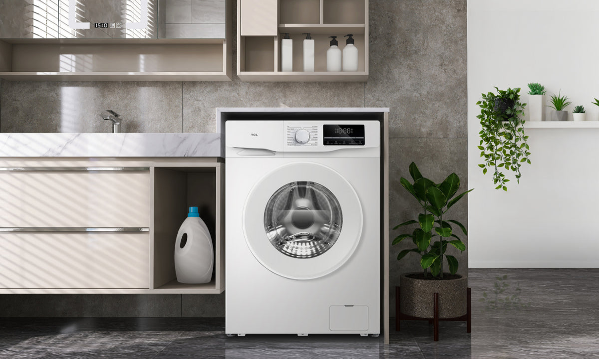 A modern gray tiled laundry room featuring a white front load washing machine 