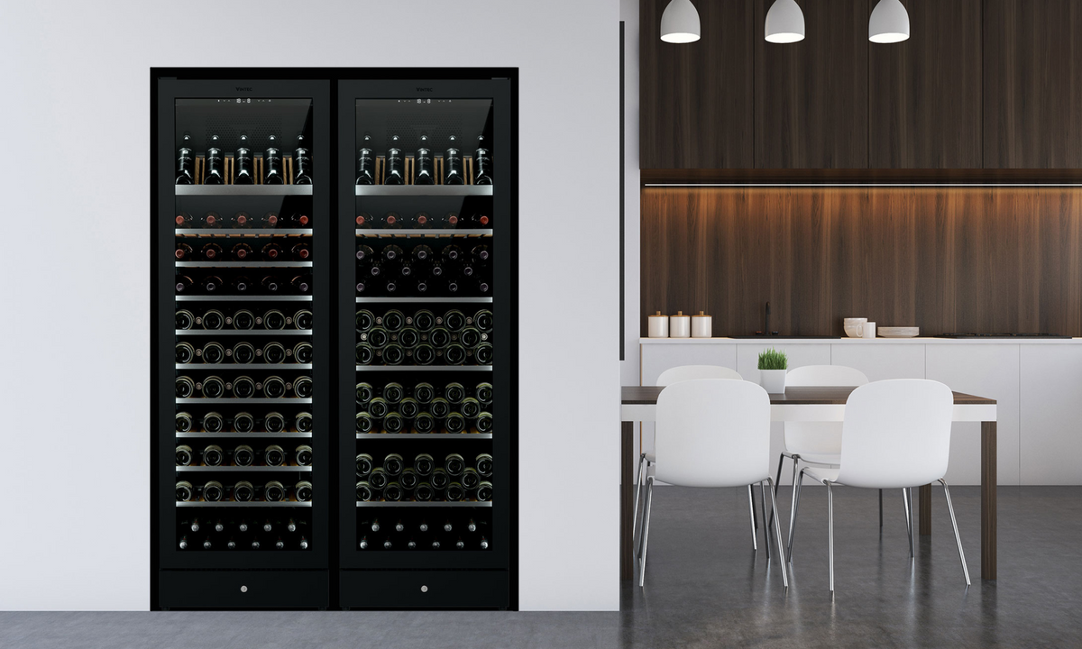 A tall black framed Wine Fridge contrasts with an open plan kitchen with pendant lighting