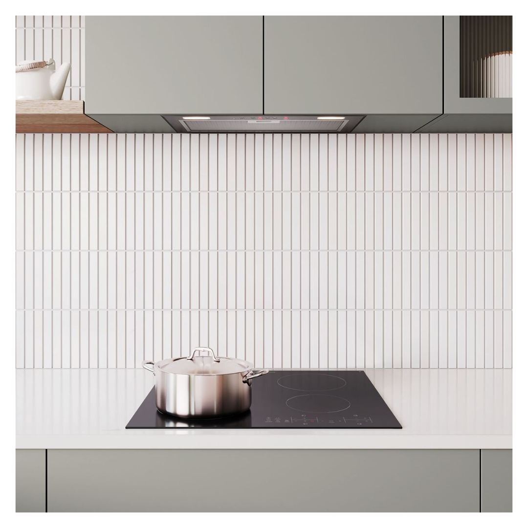 Angled view of the Westinghouse 60cm 4 zone ceramic cooktop in a modern kitchen setting with a silver pot on it and an integrated rangehood above it.