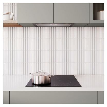 Angled view of the Westinghouse 60cm 4 zone ceramic cooktop in a modern kitchen setting with a silver pot on it and an integrated rangehood above it.