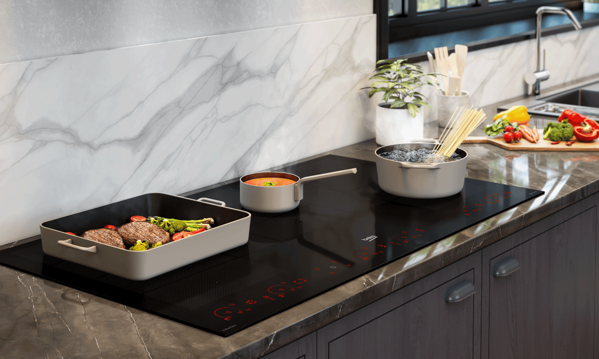 A modern kitchen cooktop with a Beko induction cooktop on display, with pots and pans on the Beko Induction Cooktop. 